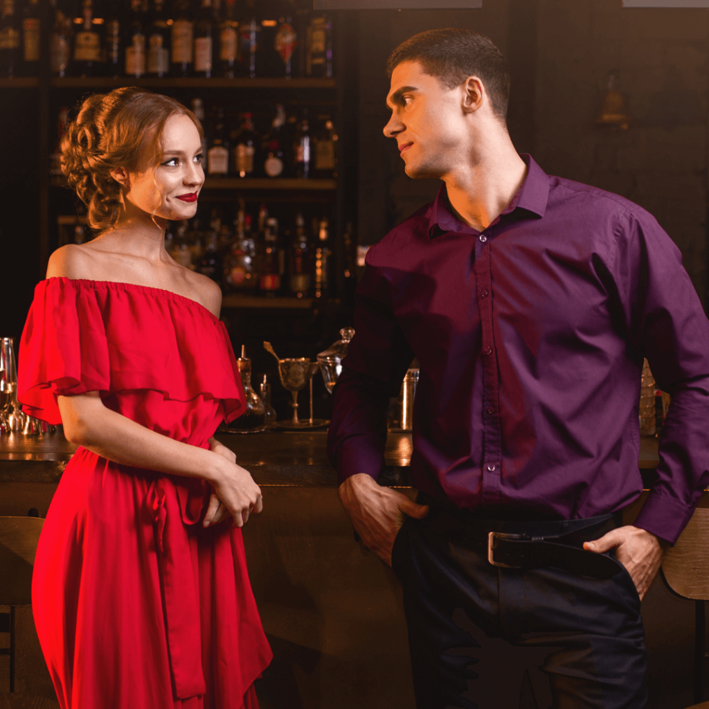 A man and woman flirting at a bar, illustrating effective dating techniques.